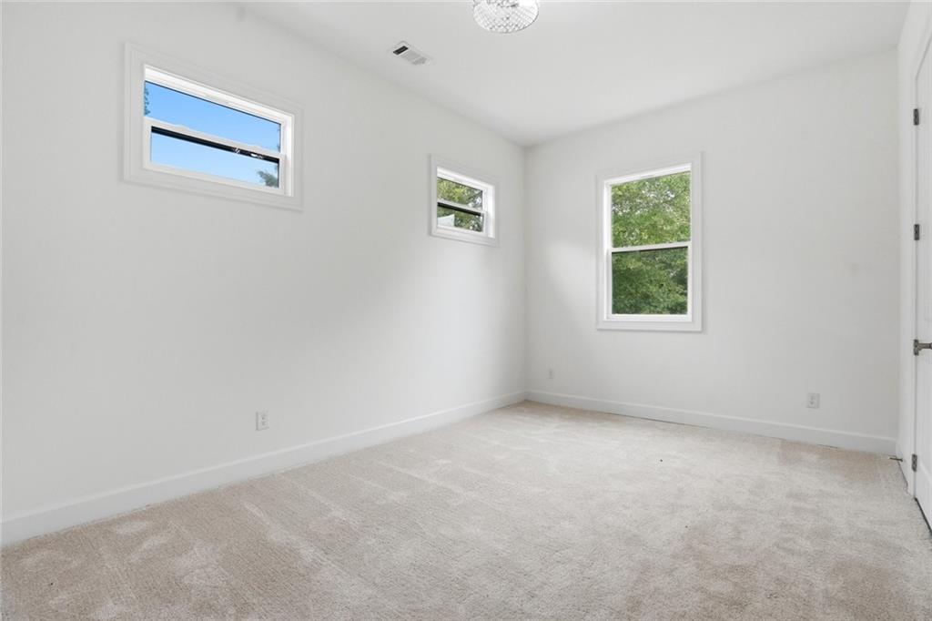 2415 West Rugby Avenue Atlanta, GA 30337 - Photo 22 of 40 an empty room with windows