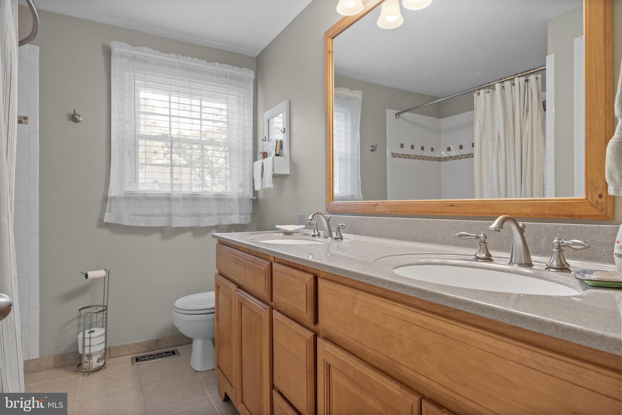 701 Decatur Drive Mount Laurel, NJ 08054 - Photo 25 of 36 a bathroom with a double vanity sink toilet and a mirror