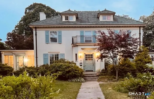 a front view of a house with a garden