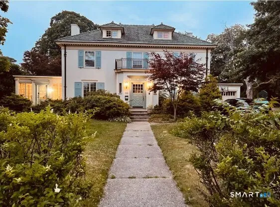 a front view of a house with garden