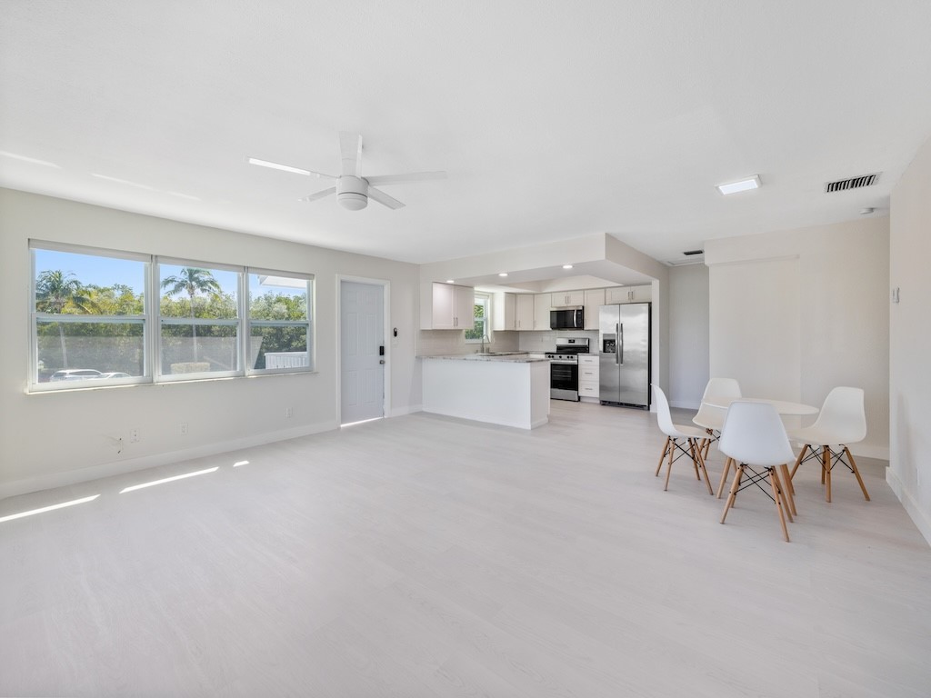 741 Hernando Street Fort Pierce, FL 34949 - Photo 26 of 36 a big room with chandelier fan and windows