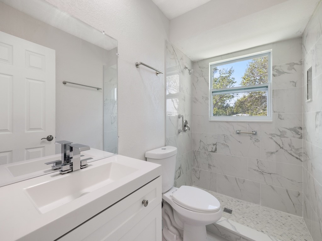 741 Hernando Street Fort Pierce, FL 34949 - Photo 9 of 36 a bathroom with a sink toilet and shower