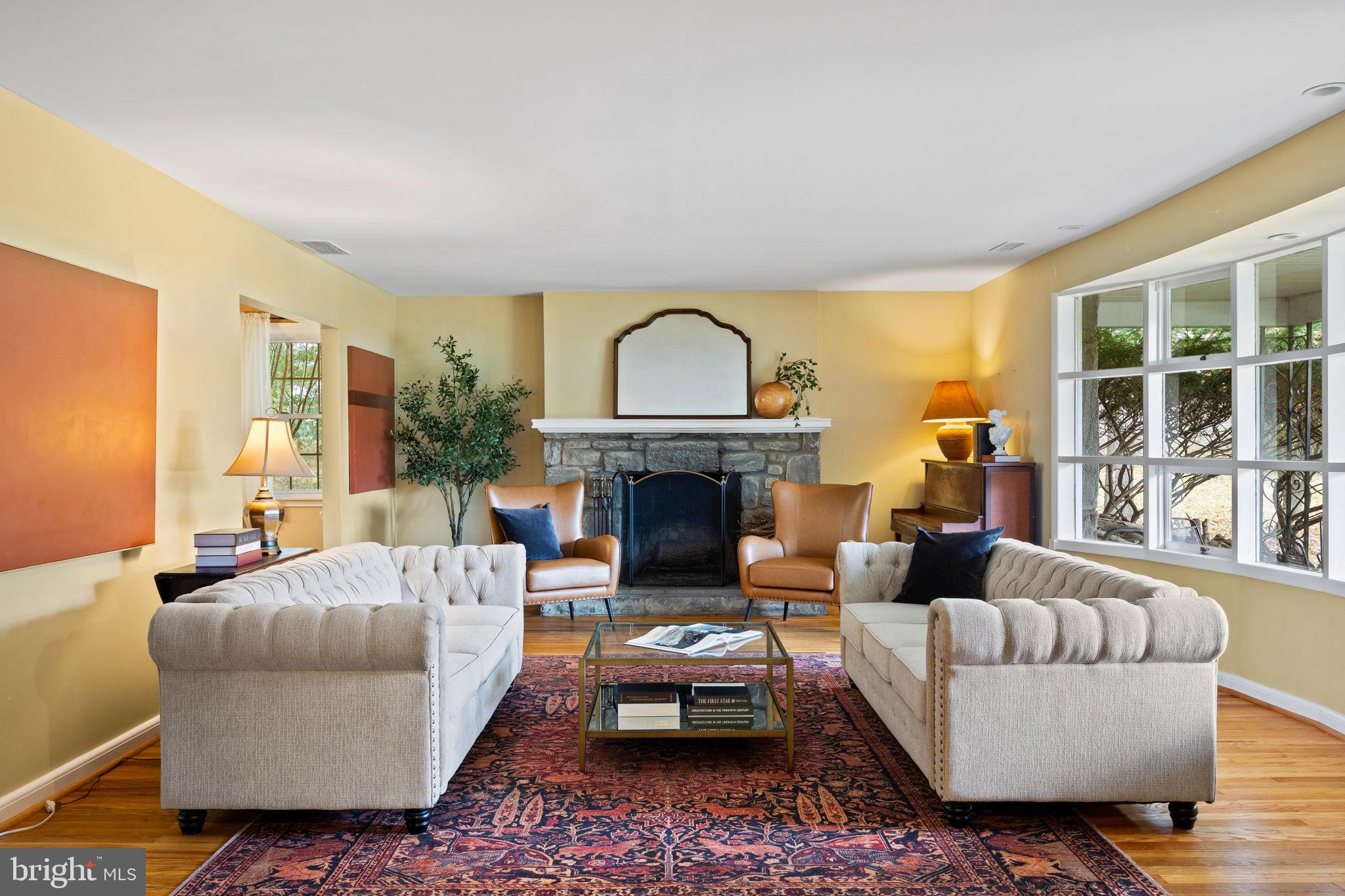 1014 Townsend Circle Wayne, PA 19087 - Photo 3 of 68 a living room with furniture a fireplace and a floor to ceiling window
