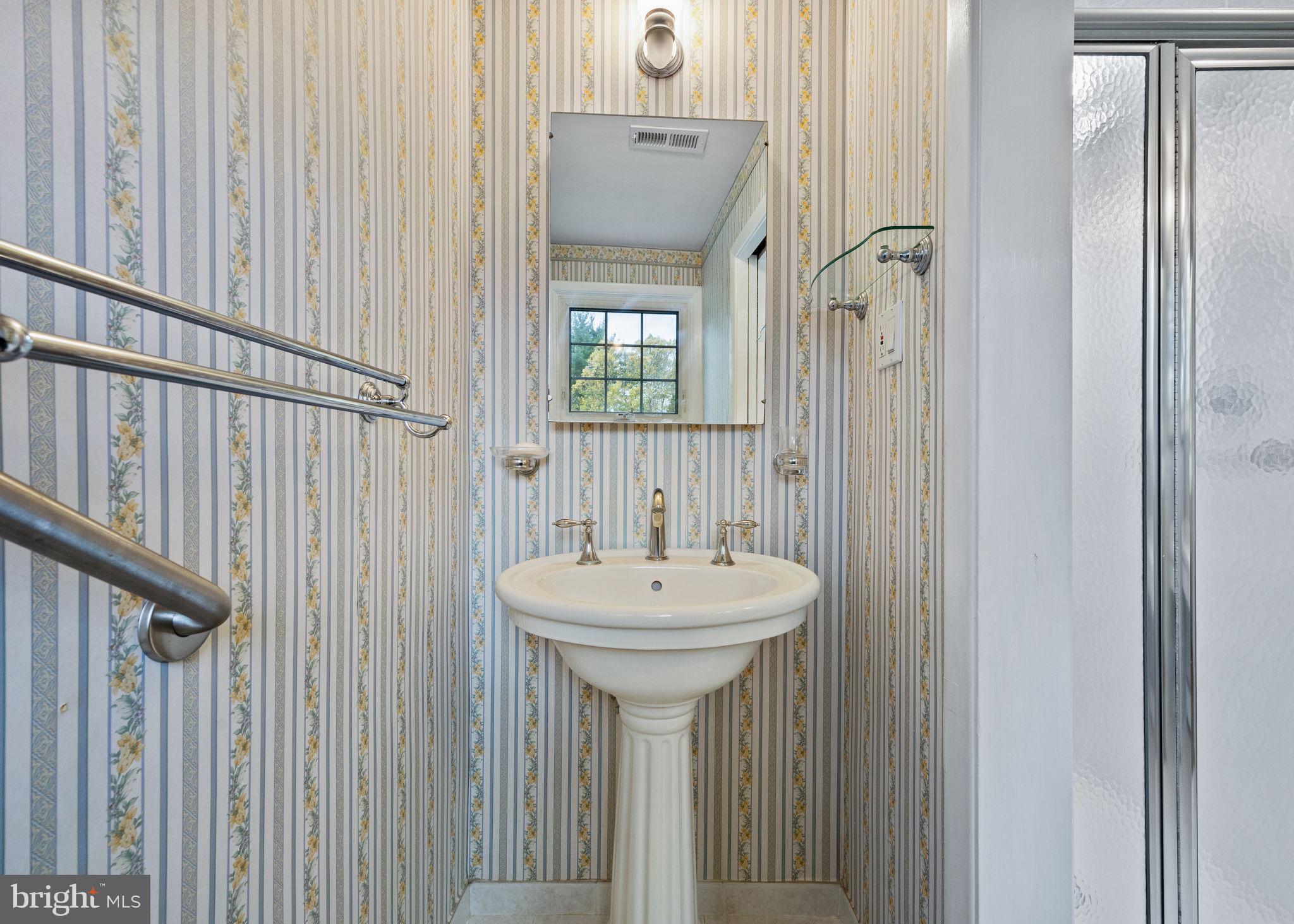 1014 Townsend Circle Wayne, PA 19087 - Photo 40 of 68 a bathroom with a sink a mirror and a window