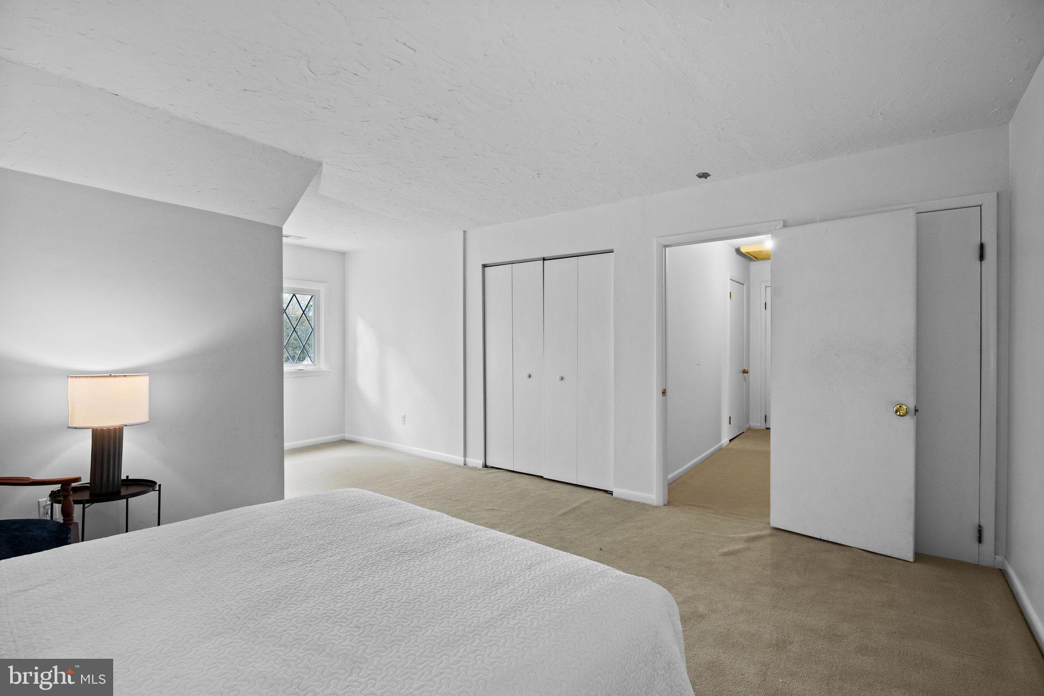 1014 Townsend Circle Wayne, PA 19087 - Photo 46 of 68 a spacious bedroom with a bed and a lamp