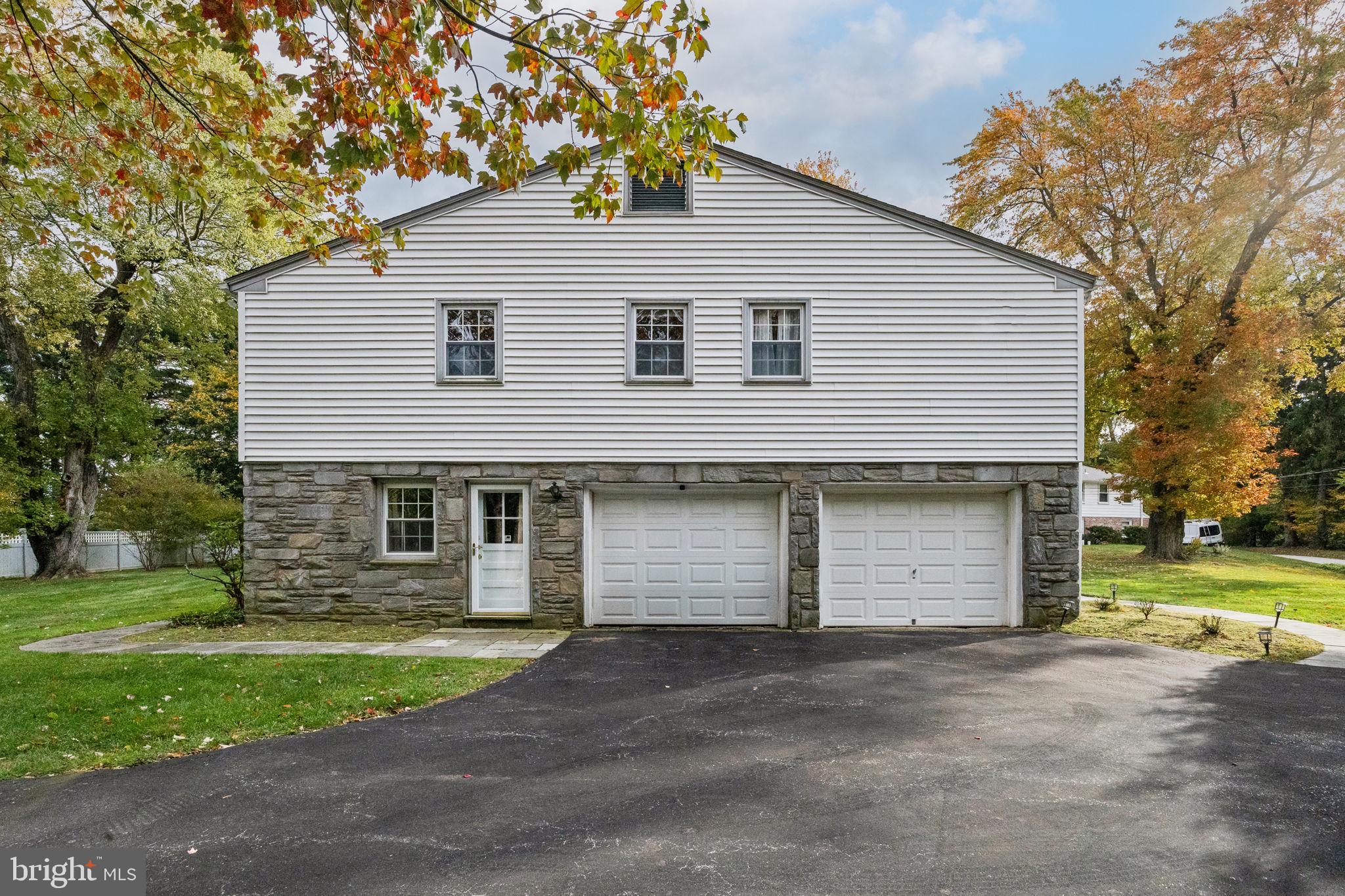 1014 Townsend Circle Wayne, PA 19087 - Photo 66 of 68 a front view of a house with a yard and garage