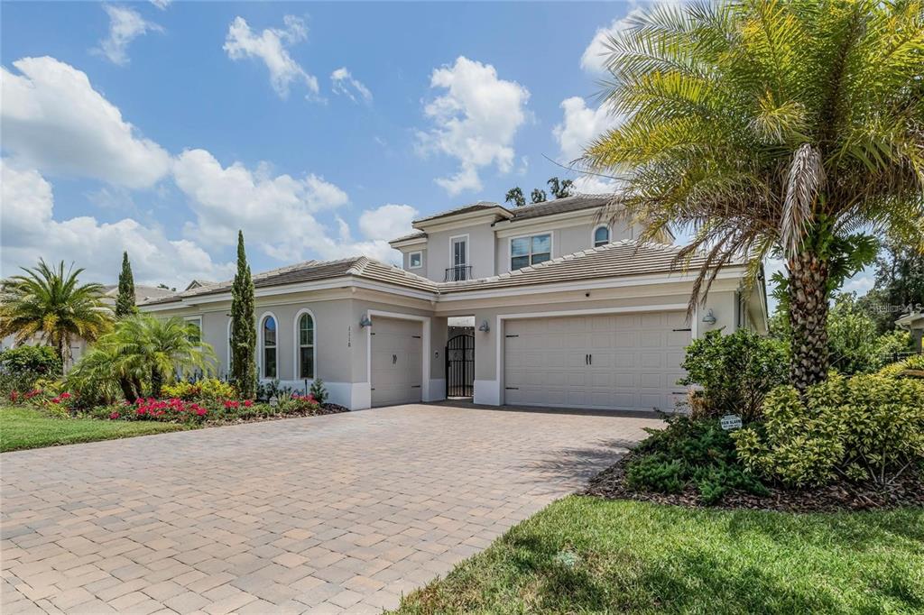 a front view of a house with a garden