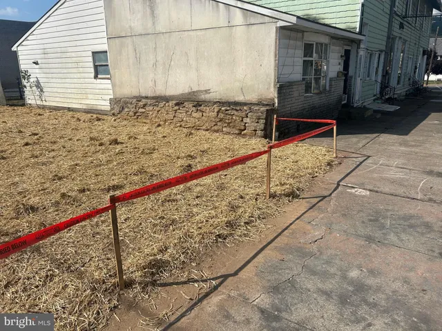 a view of a backyard with a wooden fence