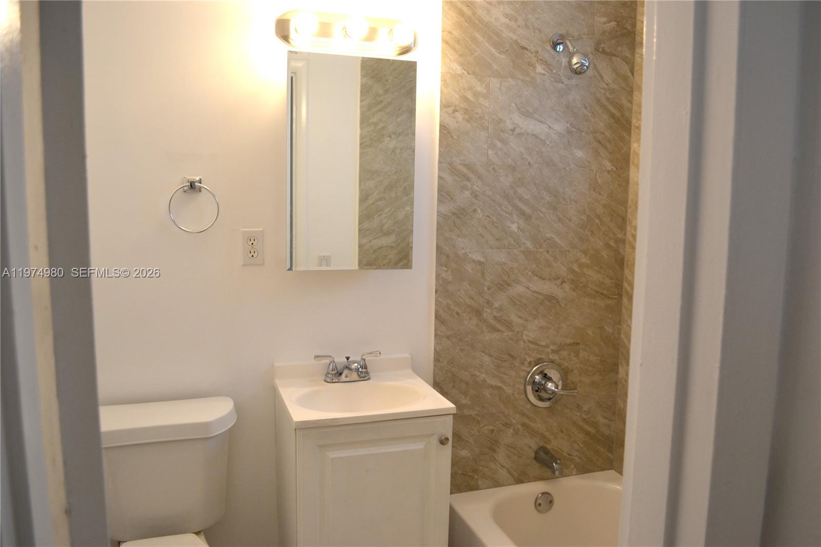1035 Southwest 4th Street, Unit 2 Miami, FL 33130 - Photo 11 of 11 a bathroom with a sink a toilet and shower