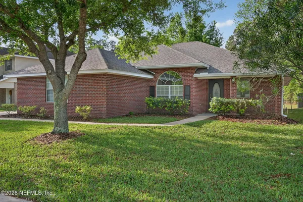 a front view of house with yard and green space