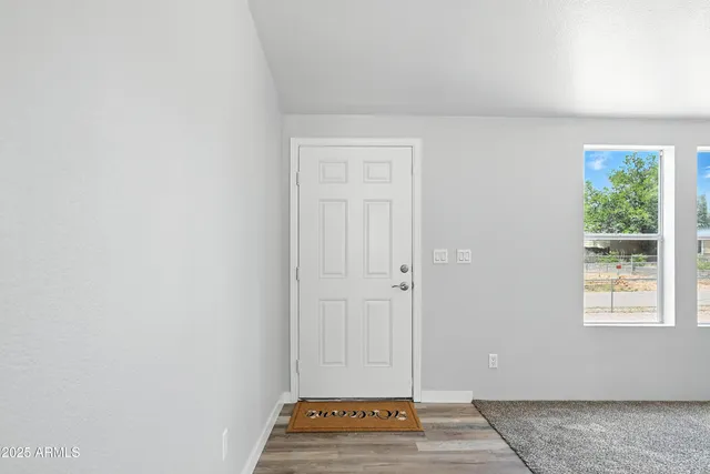 a view of a livingroom with wooden floor and a window