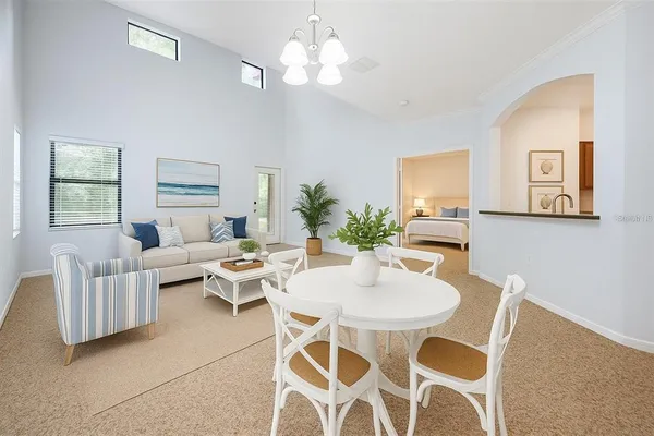 a view of a dining room with furniture and chandelier