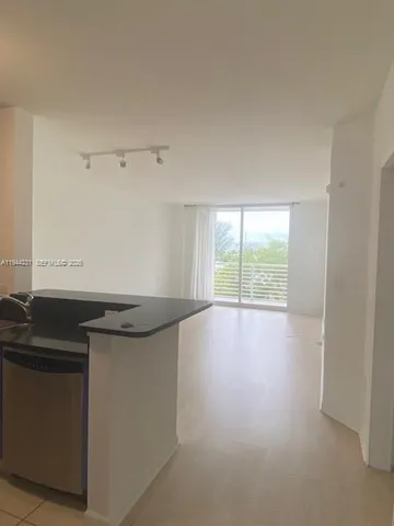 a kitchen with granite countertop a sink and a stove