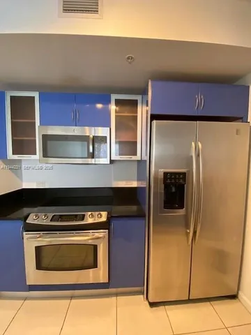 a kitchen with granite countertop a stove and a microwave