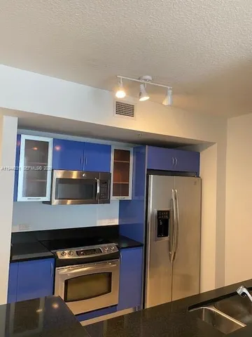 a kitchen with a stove and a microwave