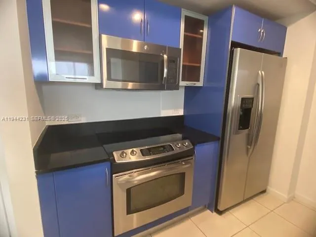 a kitchen with a refrigerator stove and microwave