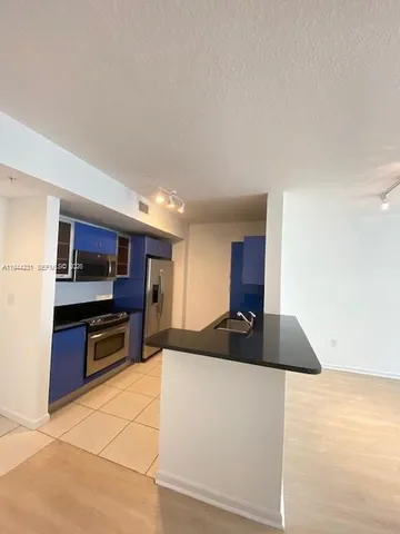 a kitchen with a sink and a stove top oven