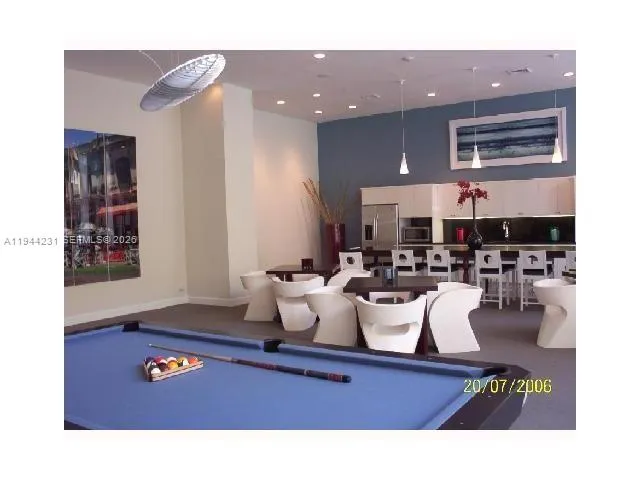 a living room with lots of white furniture and a window