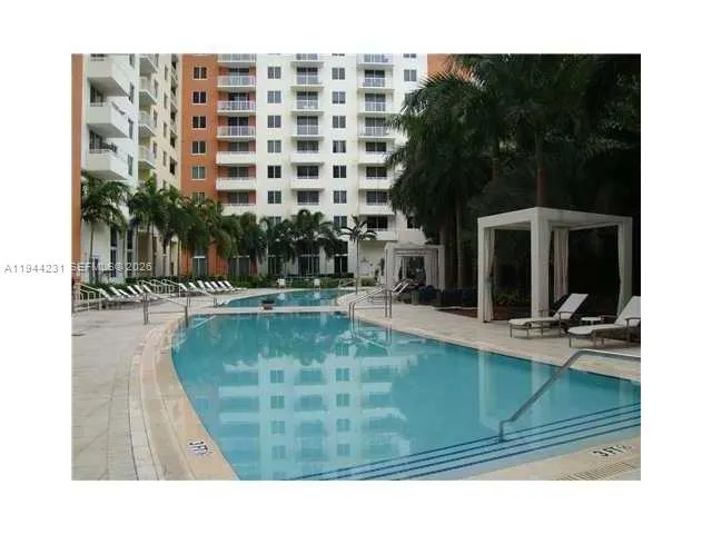 a view of swimming pool with outdoor seating and plants