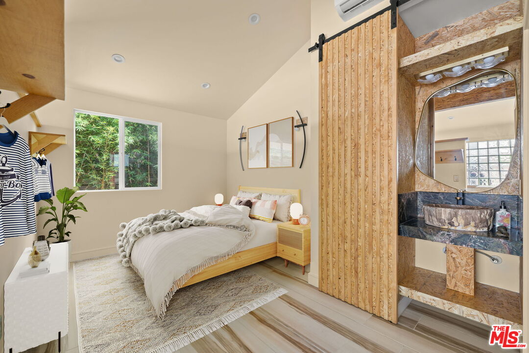 621 Rose Avenue, Unit 623 1/2 Venice, CA 90291 - Photo 7 of 10 a bedroom with a bed next to a window