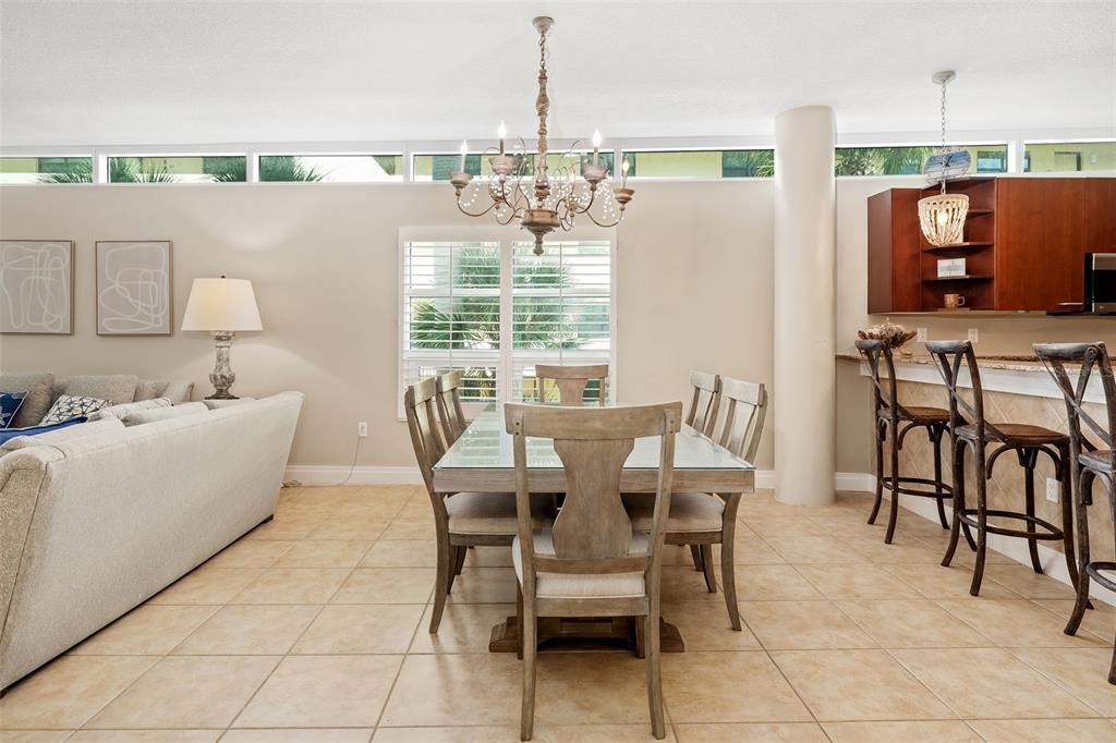 6512 Midnight Pass Road, Unit 204 Sarasota, FL 34242 - Photo 15 of 64 a view of a dining room with furniture and chandelier