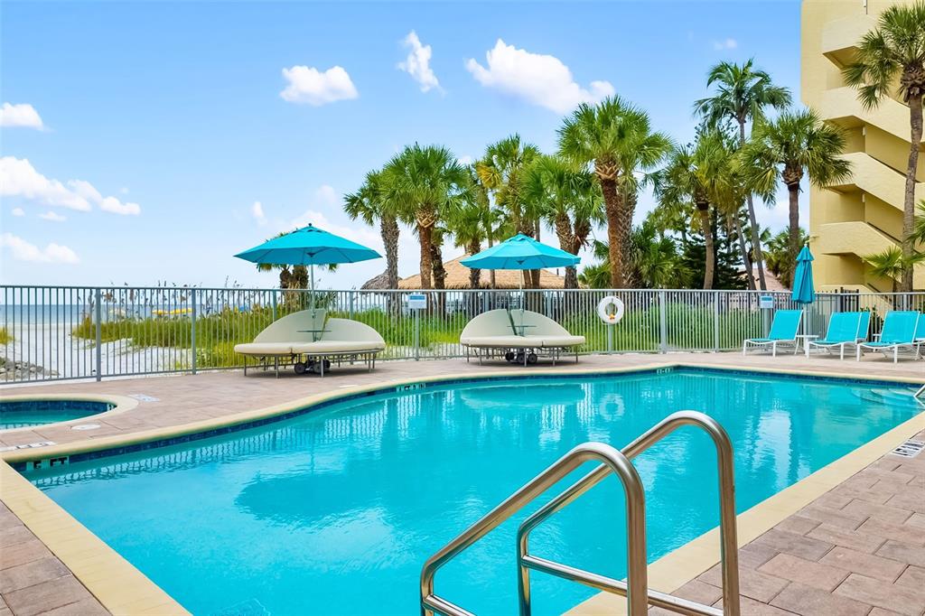 6512 Midnight Pass Road, Unit 204 Sarasota, FL 34242 - Photo 2 of 64 a view of a swimming pool with a patio and a garden