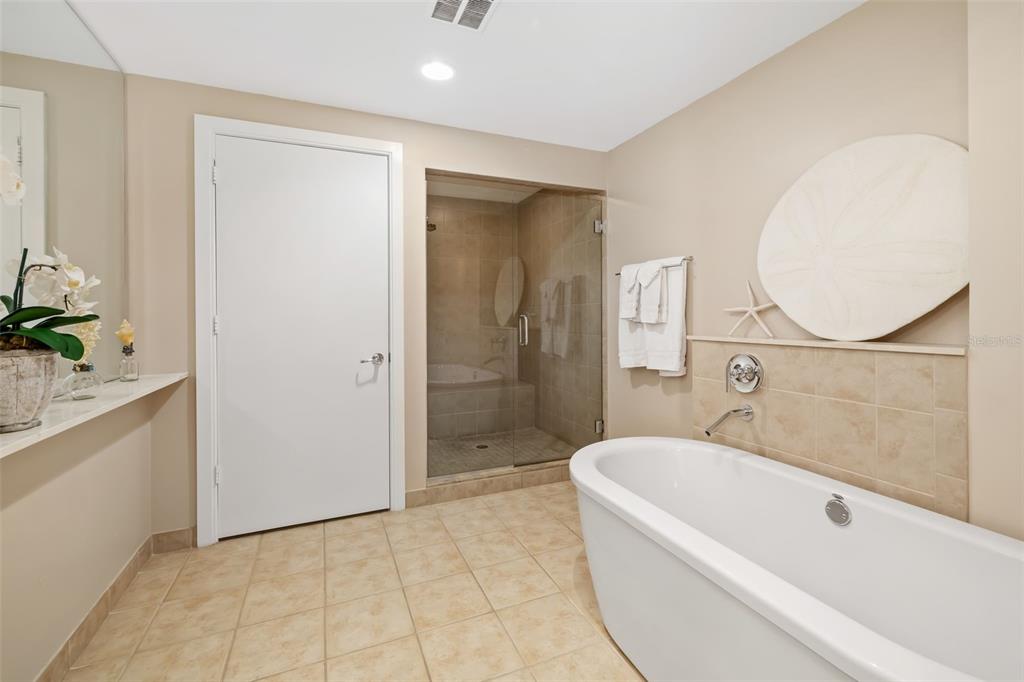 6512 Midnight Pass Road, Unit 204 Sarasota, FL 34242 - Photo 23 of 64 a bathroom with a granite countertop bathtub shower sink and mirror