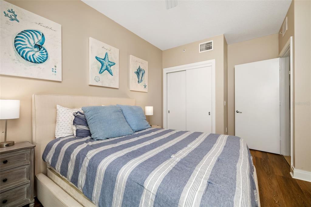 6512 Midnight Pass Road, Unit 204 Sarasota, FL 34242 - Photo 26 of 64 a bedroom with a bed and painting on the wall