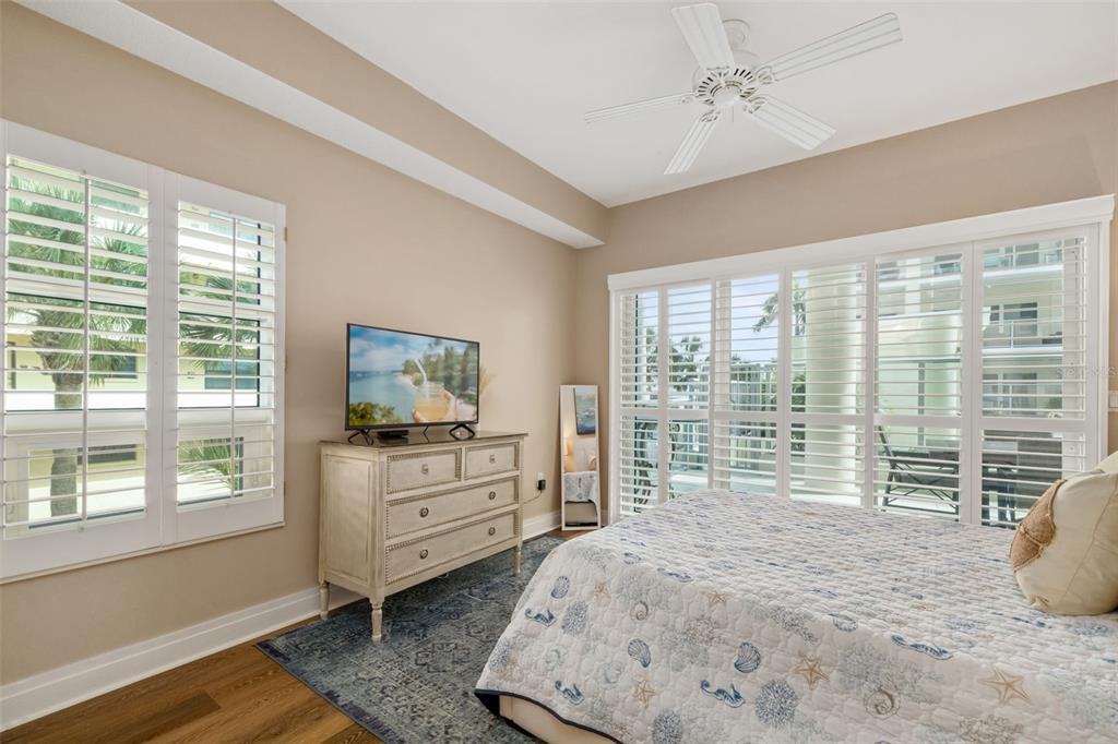 6512 Midnight Pass Road, Unit 204 Sarasota, FL 34242 - Photo 27 of 64 a bedroom with a bed and large windows