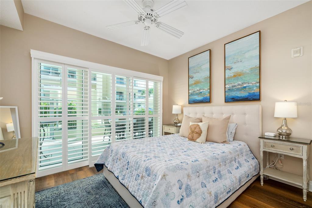 6512 Midnight Pass Road, Unit 204 Sarasota, FL 34242 - Photo 28 of 64 a bedroom with a large bed and a large window