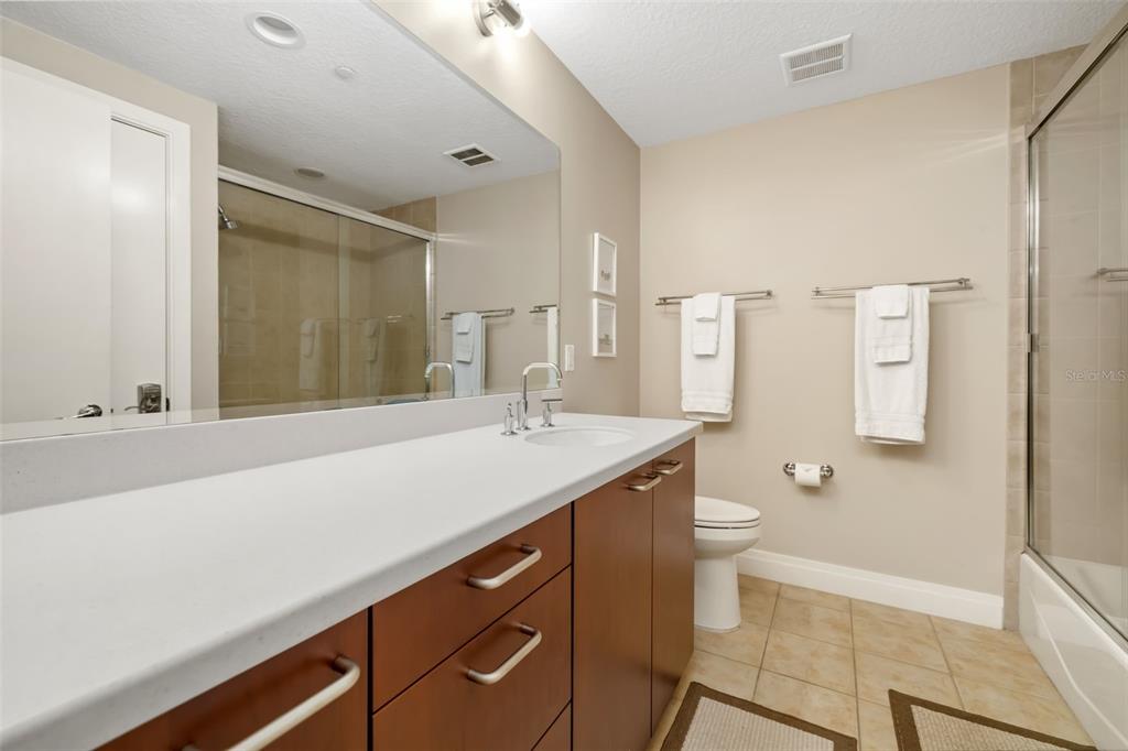 6512 Midnight Pass Road, Unit 204 Sarasota, FL 34242 - Photo 29 of 64 a bathroom with a sink a toilet and shower