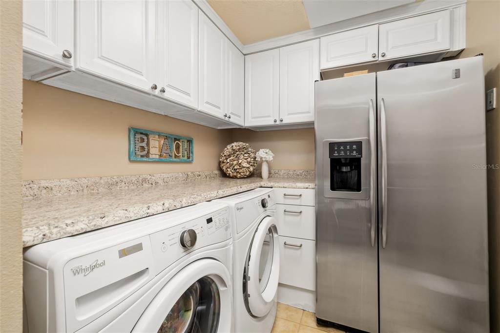 6512 Midnight Pass Road, Unit 204 Sarasota, FL 34242 - Photo 32 of 64 a view of kitchen with stainless steel appliances cabinets and a counter top space