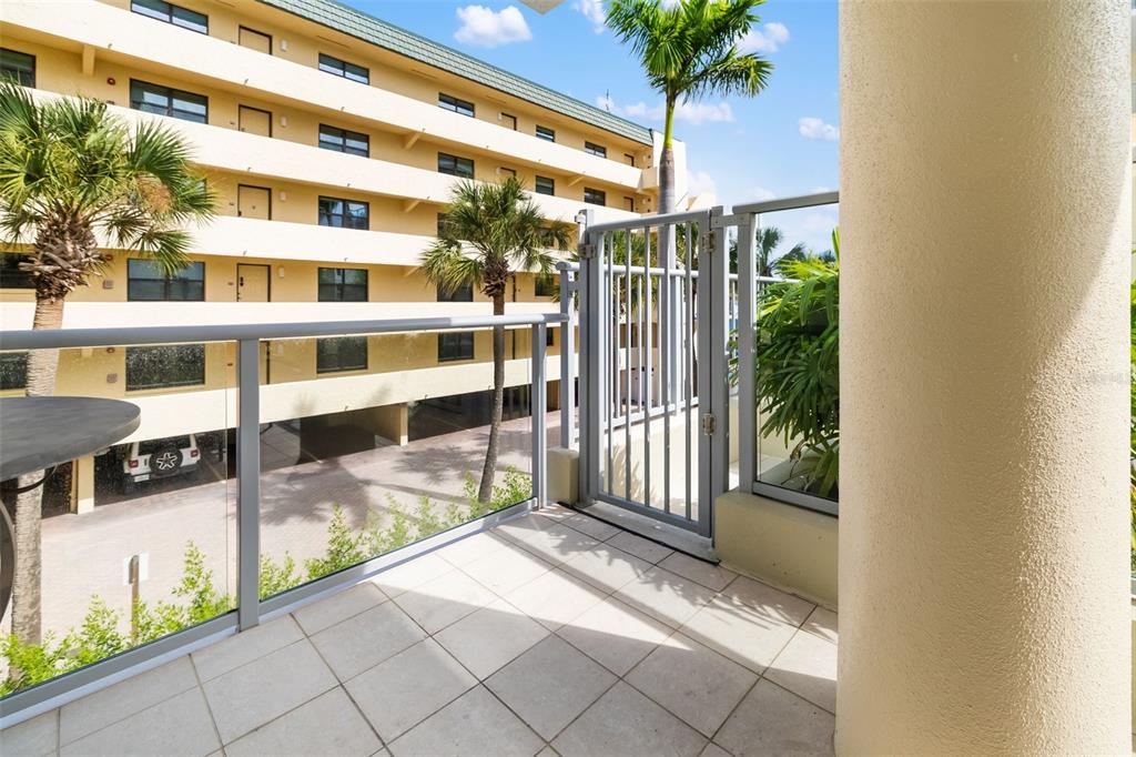 6512 Midnight Pass Road, Unit 204 Sarasota, FL 34242 - Photo 35 of 64 a view of a balcony with potted plants