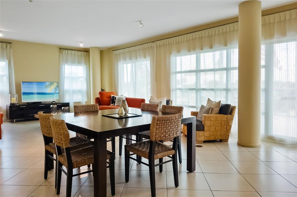 6512 Midnight Pass Road, Unit 204 Sarasota, FL 34242 - Photo 43 of 64 a view of a dining room with furniture and a window