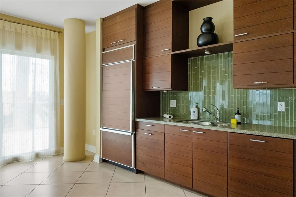 6512 Midnight Pass Road, Unit 204 Sarasota, FL 34242 - Photo 44 of 64 a kitchen with a sink and a refrigerator