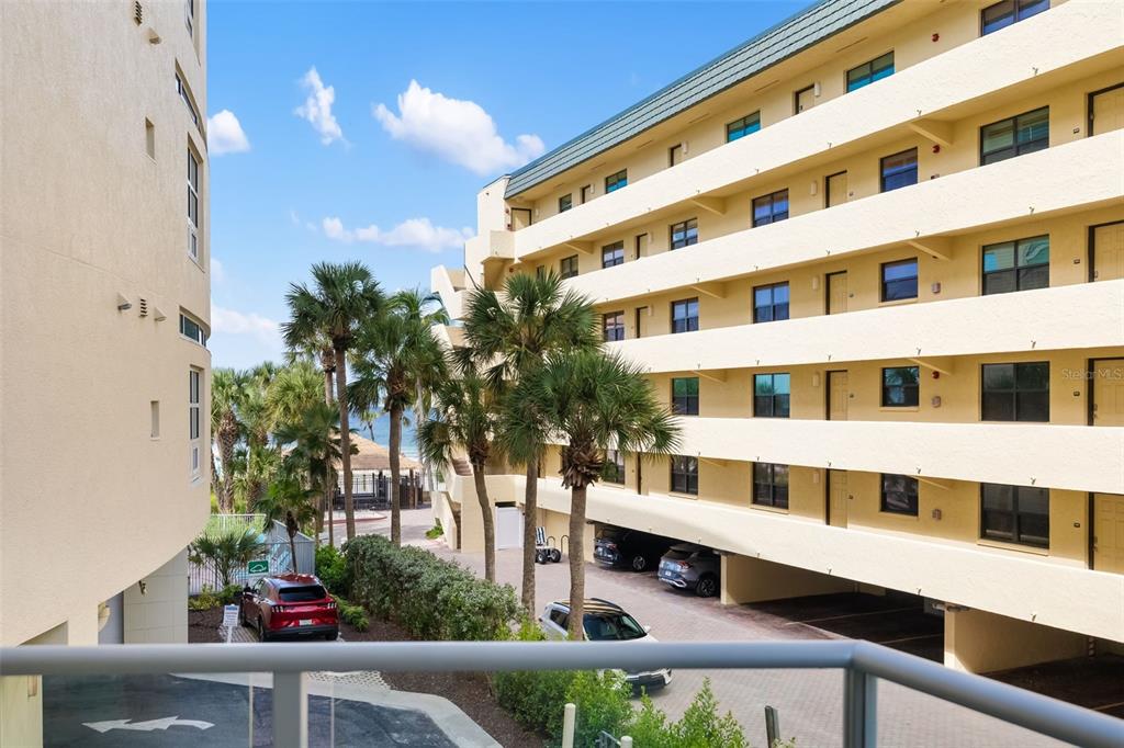 6512 Midnight Pass Road, Unit 204 Sarasota, FL 34242 - Photo 7 of 64 a view of building with yard and balcony