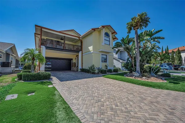 a front view of a house with a yard and a garage
