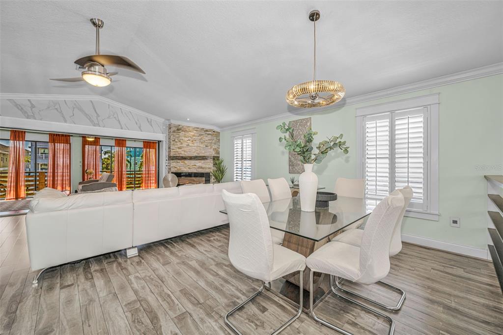 6009 Bayway Court New Port Richey, FL 34652 - Photo 13 of 93 a dining room with chandelier fan and wooden floor