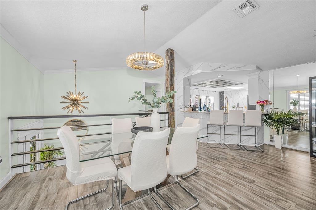 6009 Bayway Court New Port Richey, FL 34652 - Photo 16 of 93 a view of a dining room with furniture and wooden floor