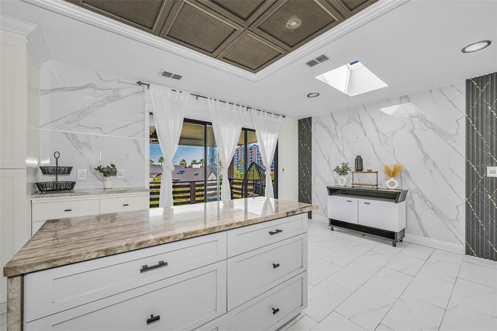 6009 Bayway Court New Port Richey, FL 34652 - Photo 18 of 93 a spacious en suite bathroom with a granite countertop tub a double vanity sink and a mirror
