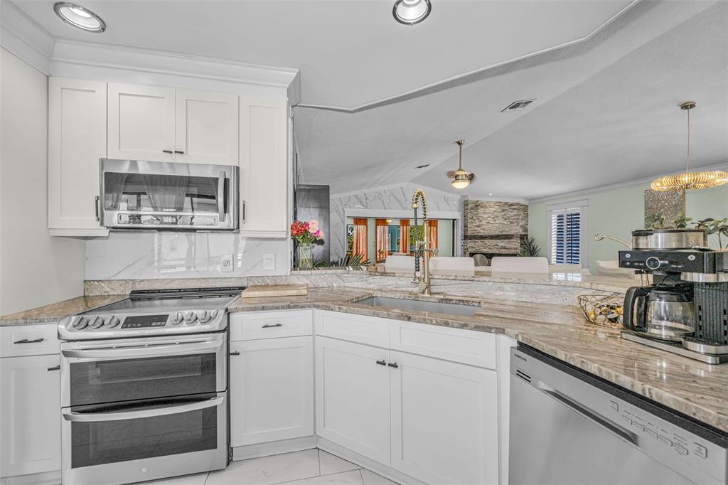 6009 Bayway Court New Port Richey, FL 34652 - Photo 21 of 93 a kitchen with a stove and cabinets