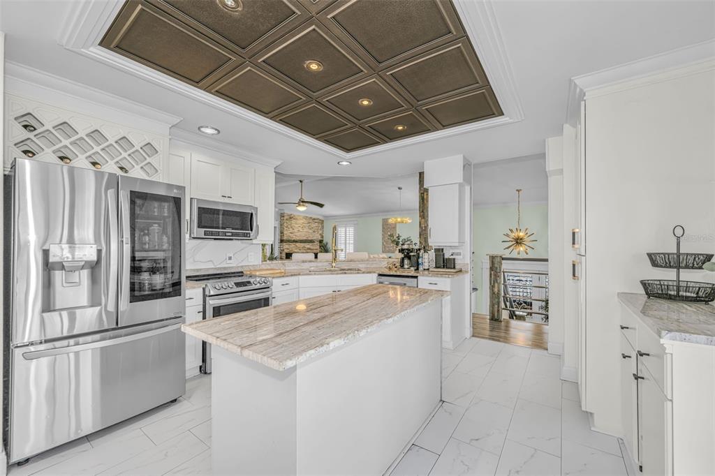 6009 Bayway Court New Port Richey, FL 34652 - Photo 24 of 93 a large white kitchen with lots of counter space and stainless steel appliances
