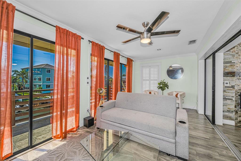 6009 Bayway Court New Port Richey, FL 34652 - Photo 35 of 93 a living room with a balcony a bed furniture and a window