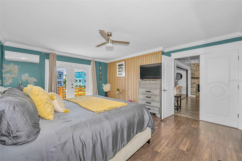 6009 Bayway Court New Port Richey, FL 34652 - Photo 44 of 93 a spacious bedroom with a bed and a flat screen tv