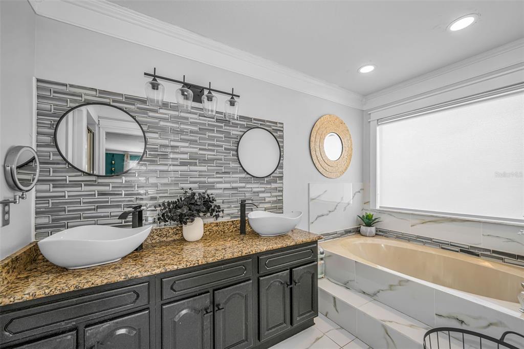 6009 Bayway Court New Port Richey, FL 34652 - Photo 48 of 93 a bathroom with a granite countertop double vanity sink and a mirror
