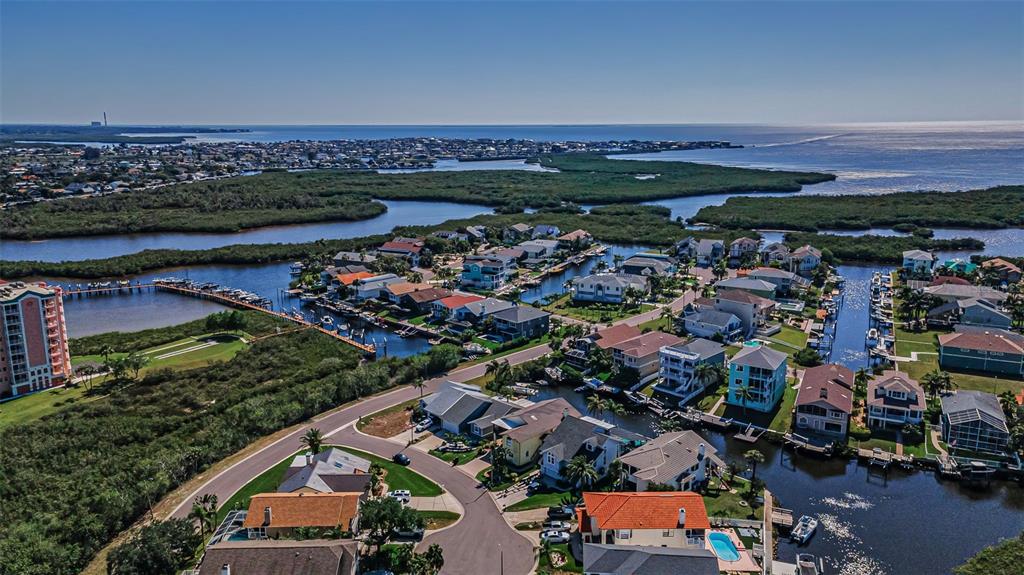 6009 Bayway Court New Port Richey, FL 34652 - Photo 79 of 93 an aerial view of a city with lots of residential buildings ocean and mountain view in back