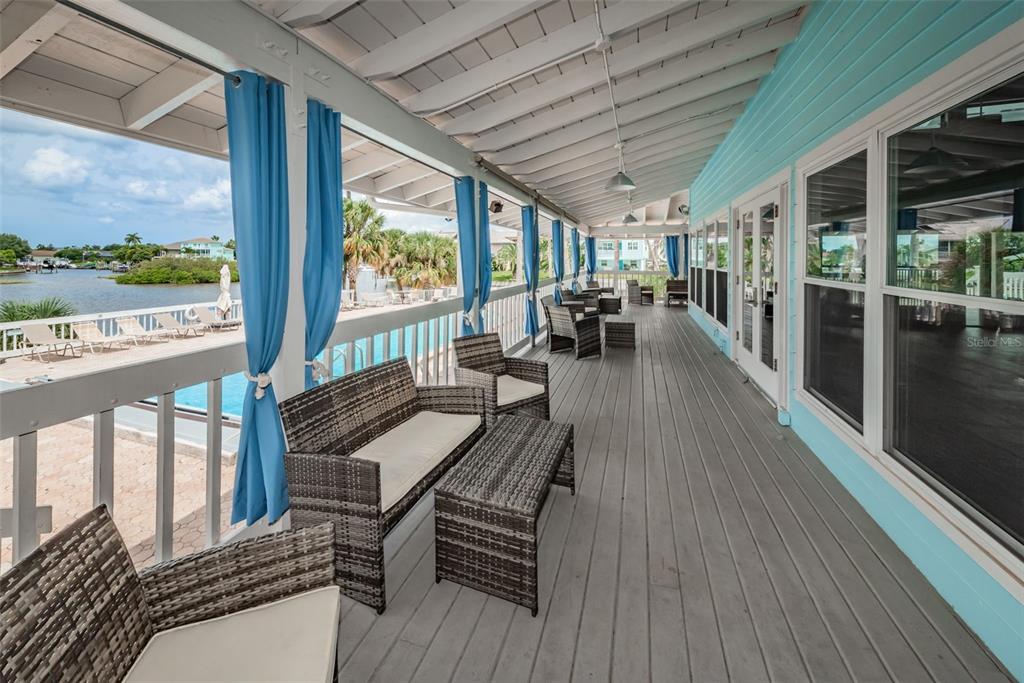 6009 Bayway Court New Port Richey, FL 34652 - Photo 85 of 93 a view of a patio with a table chairs and a wooden deck