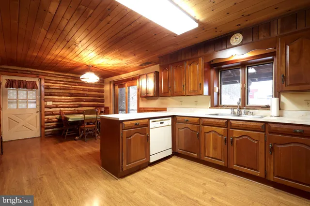 a living room with furniture a flat screen tv and gym equipment
