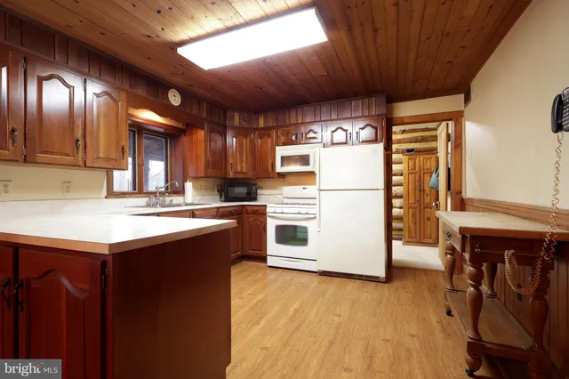 a view of a porch with wooden floor and a fireplace