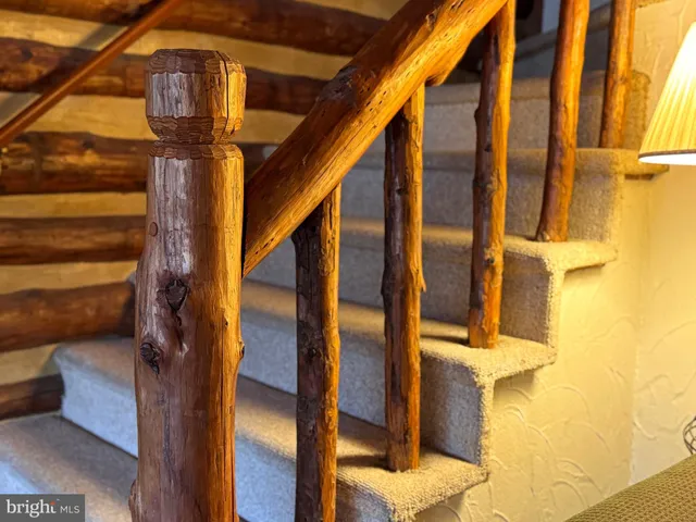 a view of a house with a yard and a wooden fence
